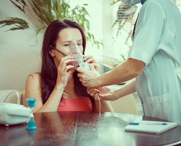 Nurse helping patient at home to use her new medical device