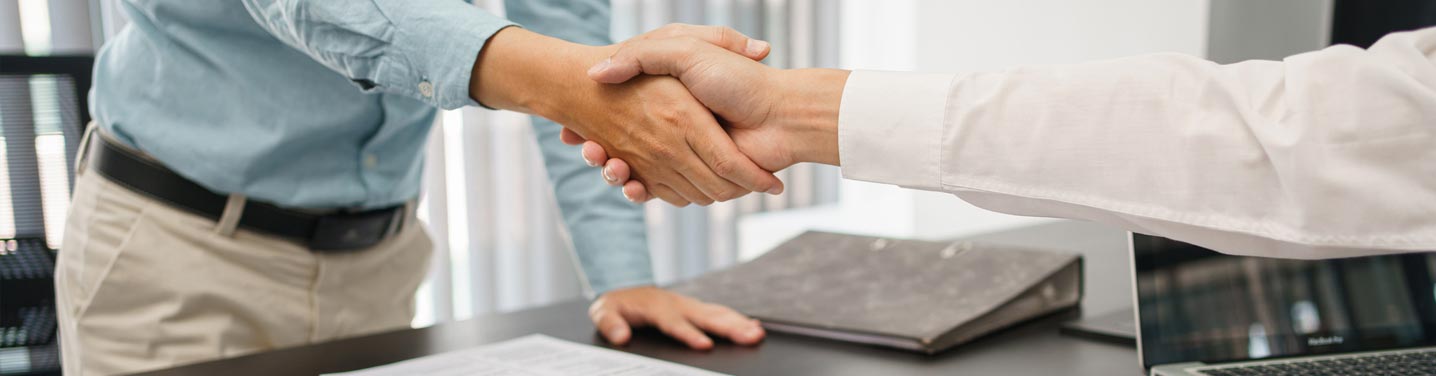 Job applicant accepting new position with a handshake