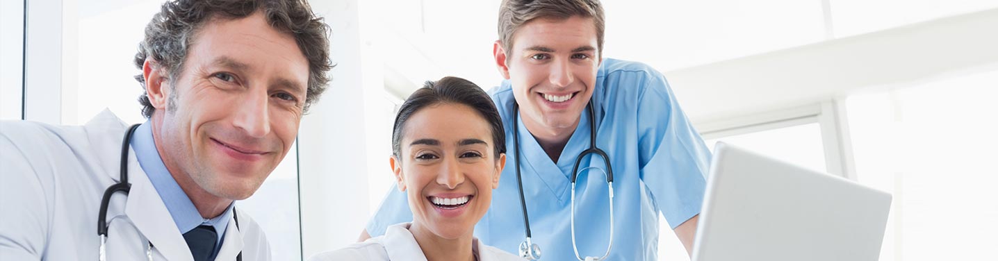 Doctor helping a nurse put an order in